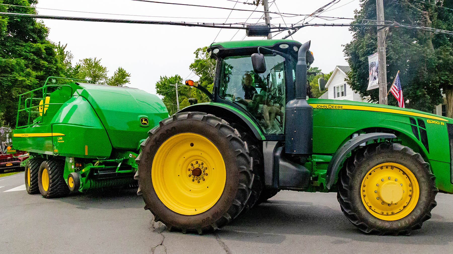 Color photo of a large tractor from Old McDonald's Farm turning onto Main Street during the Can-Am Festival parade