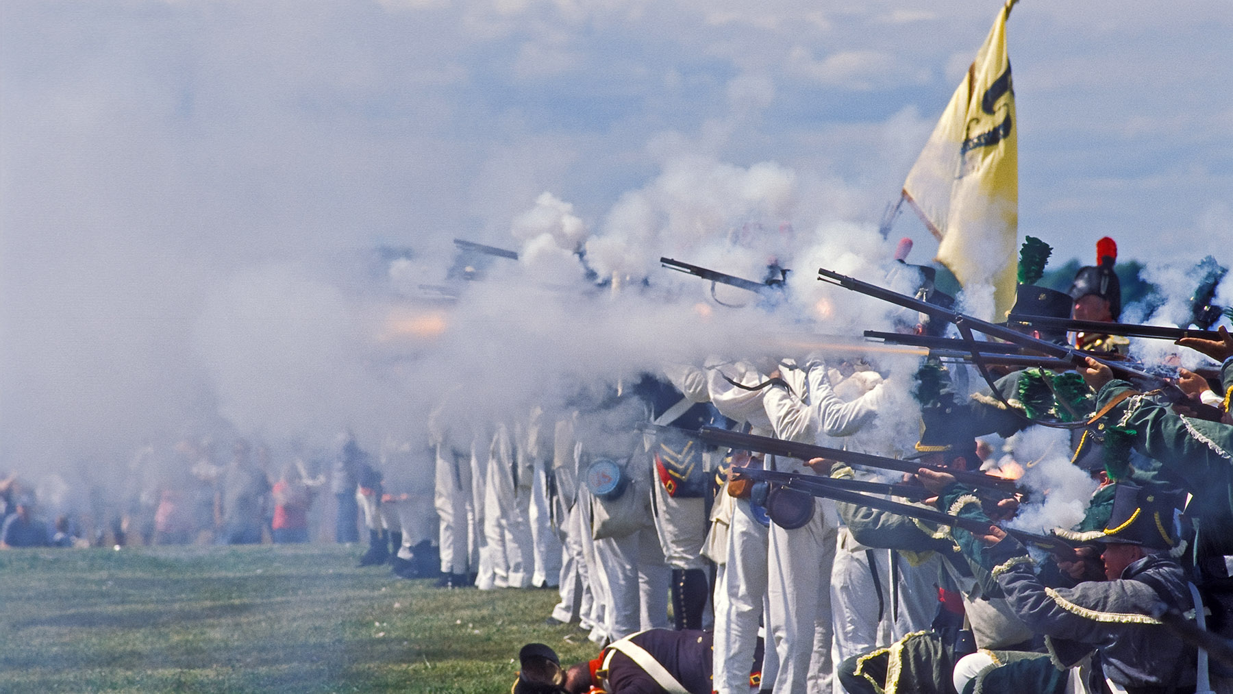 Photo of reenactors firing in a line from the last Grand Tactical in Sackets Harbor