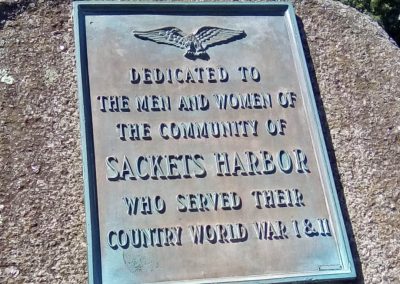 Portrait photo of a stone monument dedicated to Sackets Harbor veterans from World Wars I and II, nicknamed "Eagle Rock"; 2024 Photo Contest winner in the Under 18, Historic Sackets Harbor category, by Genevieve Hughes