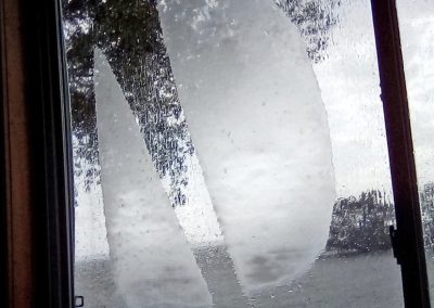 Landscape photo of condensation on a window that looks out onto Lake Ontario; 2024 Photo Contest winner in the Under 18, Nature in Action category, by Joseph Hughes
