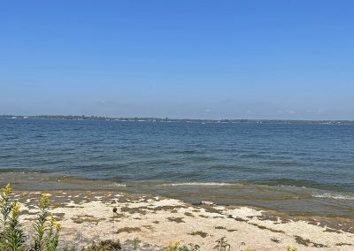 Landscape photo of Lake Ontario, taken from the shore in Sackets Harbor; 2024 Photo Contest winner in the Water and Boats category, by Brenda Jock Derouin