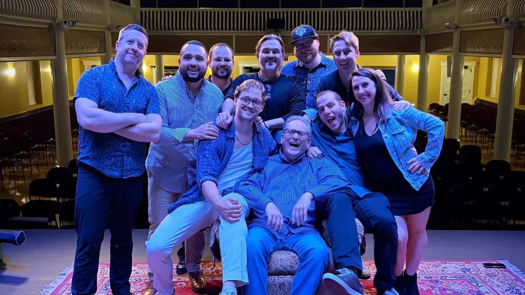 Color photo of members of The Brighton Beat Band posing on stage at the Clayton Opera House