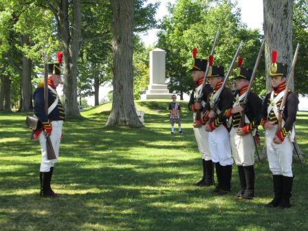 Reenactors dressed in full military uniform at the Sackets Harbor Battlefield