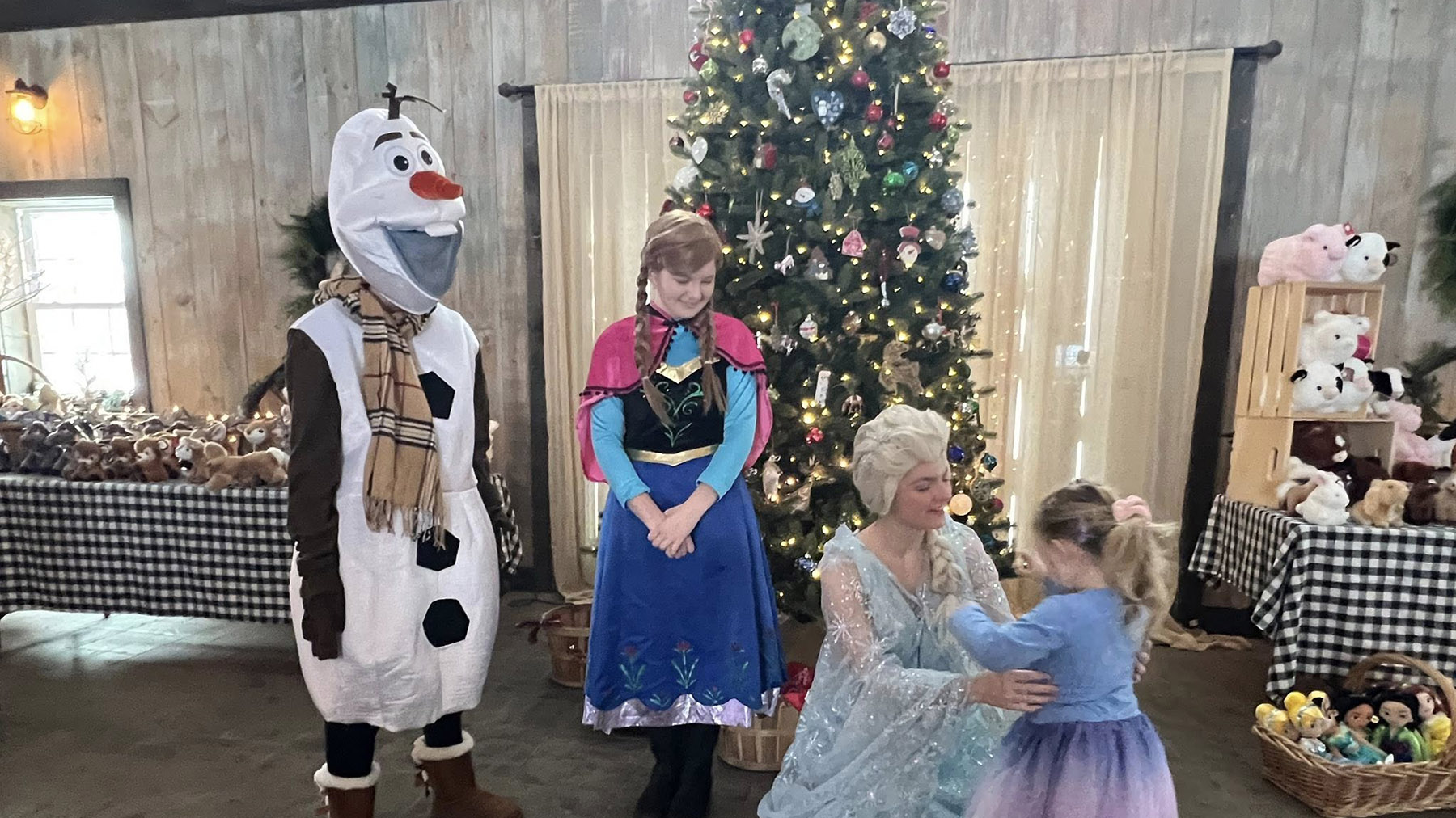 Color photo of costumed characters at Old McDonald's Farm Christmas on the Farm event in 2024